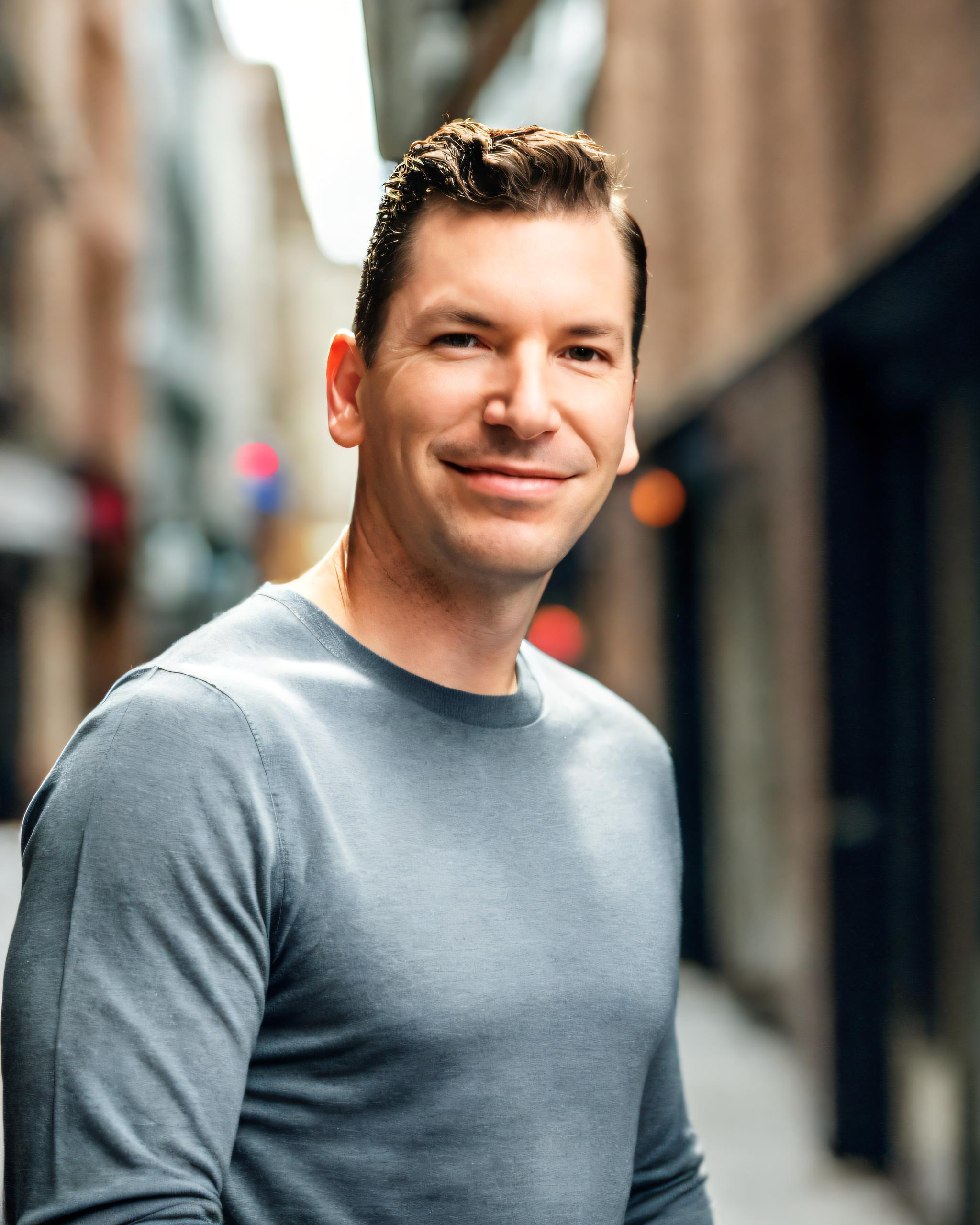 Neil Colvin, CEO of Columbus Marketing Experts, is standing in a business district in downtown Columbus Ohio.