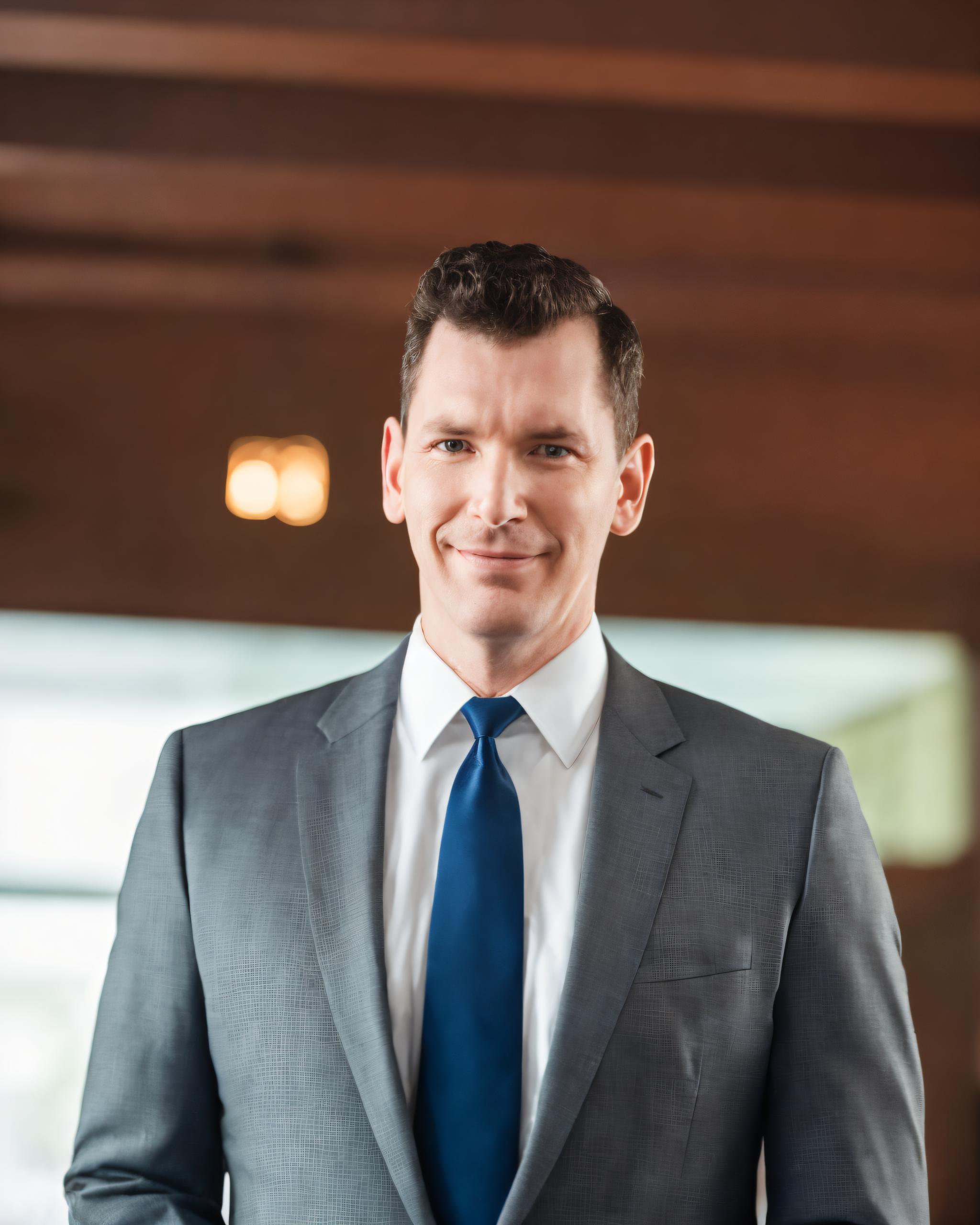 Add Another Location to Google My Business explained by CEO of Columbus Marketing Experts, Neil Colvin wearing a grey suit.